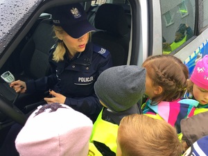 policjantka pokazuje dzieciom wyposażenie radiowozu