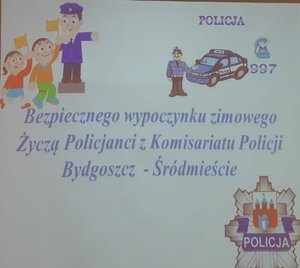 Slajd z życzeniami dla dzieci od policjantów z komisariatu Śródmieście.