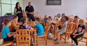 DZIECI I POLICJANCI PODCZAS SPOTKANIA W SALI.