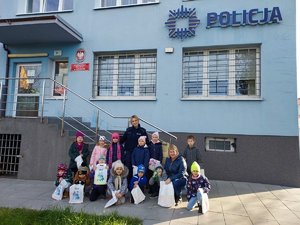 wspólne zdjęcie policjantki z dziećmi na tle komisariatu