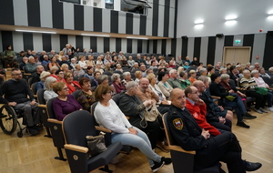 seniorzy siedzący w auli widowiskowej