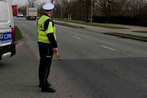 policjant stoi przy drodze