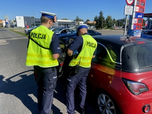 Policjanci ruchu drogowego podczas działań na drodze.