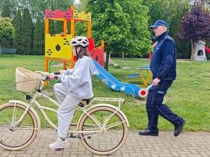 Dzielnicowy i uczniowie podczas egzaminu praktycznego na kartę rowerową.