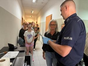 Podopieczni Warsztatu Terapii Zajęciowej, ich opiekunowie oraz policjanci podczas spotkania.
