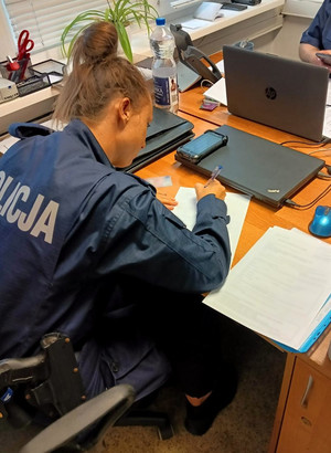 policjanci prowadzą zatrzymanego i sporządzają dokumentację