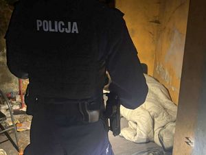Policjant podczas sprawdzania miejsca przebywania osoby w kryzysie bezdomności.